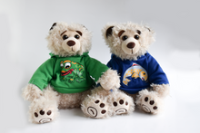Load image into Gallery viewer, Two plush beige colored bears sit in front of a white background. The bear on the left has a green hoodie with a frog and the right bear has a blue hoodie with a salmon on it.