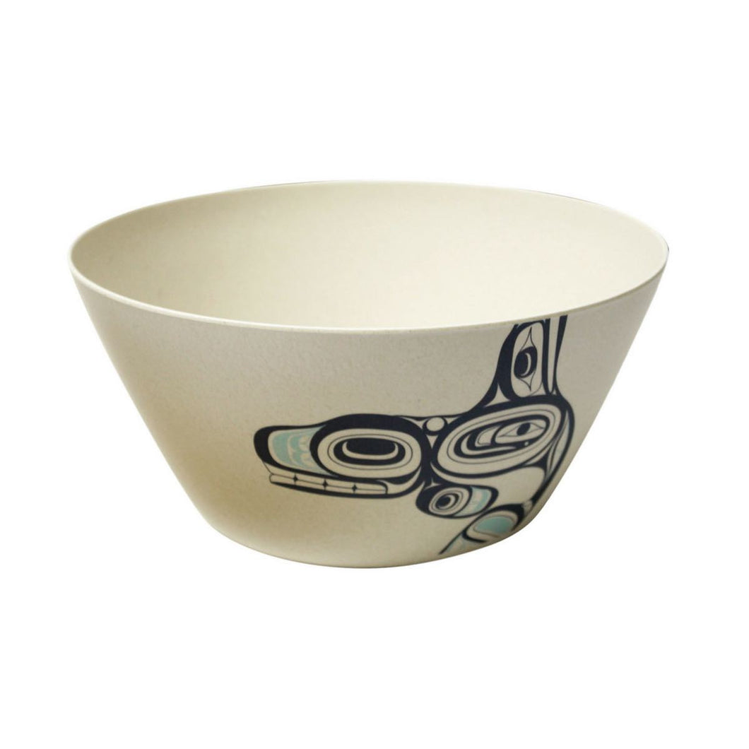 a small off white bowl with a formline whale design. the Whale is black with blue accents.