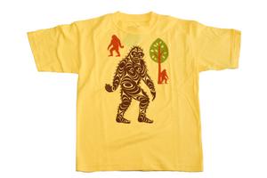 Yellow children's t shirt featuring brown sasquatch in the middle with two smaller ones and a tree in the background