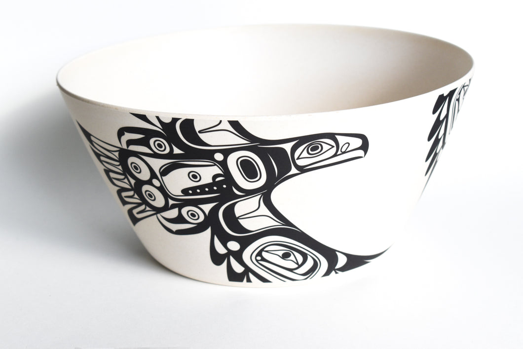 A large off white Bowl, with a black formline design of Eagle flying on the side.