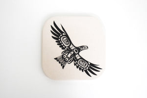 an off white coaster with a black formline design of Eagle Flying